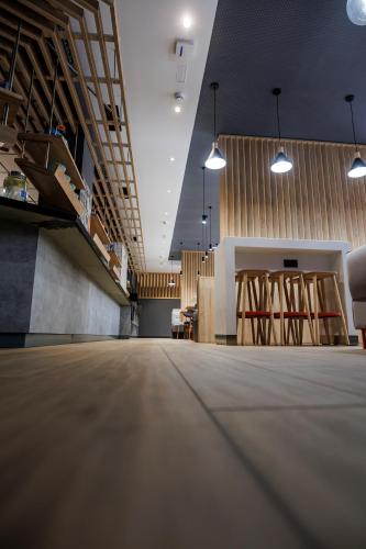 a large empty room with wooden floors and lights at ibis budget Logroño Centro in Logroño