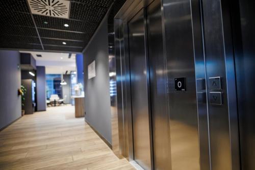 an office hallway with metal doors and wooden floors at ibis budget Logroño Centro in Logroño