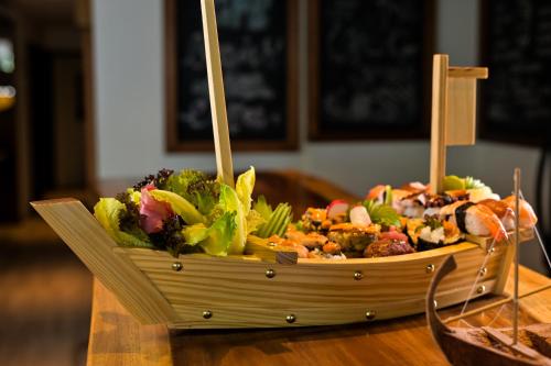 a salad in a wooden bowl on a table at Seasalter Maldives in Hulhumale