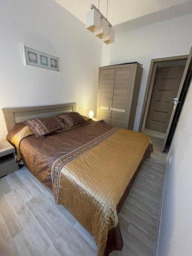a bedroom with a large bed in a room at Taikos Apartmentai 2 in Druskininkai