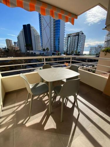 a table and chairs on a balcony with a view of a city at Calpe Apolo V 3B Appartement Marrakech Style in Calpe