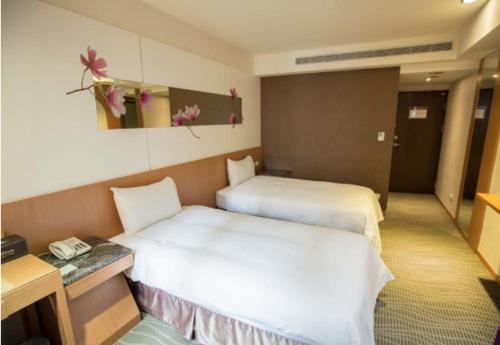 Postel nebo postele na pokoji v ubytování Ximen Relite Hotel