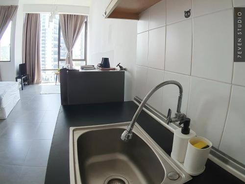 a kitchen with a sink with a faucet at Five Studio - Empire Damansara in Petaling Jaya