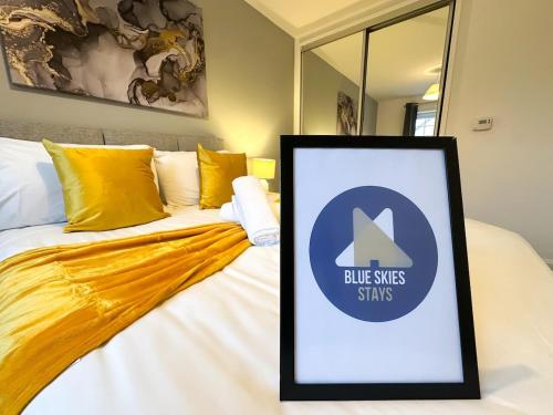 a framed sign on a bed in a room at No 9 by Blue Skies Stays in Thornaby on Tees