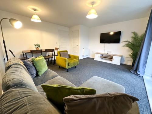 a living room with a couch and a dining room at No 9 by Blue Skies Stays in Thornaby on Tees