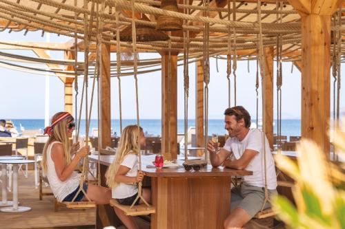 a group of people sitting at a table in a restaurant at Belambra Clubs Presqu'île De Giens - Riviera Beach Club in Hyères