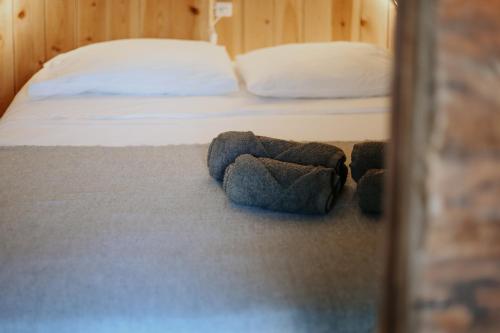 a bedroom with a bed with a blue stuffed animal on the floor at Banana Eco Camp in Angra do Heroísmo