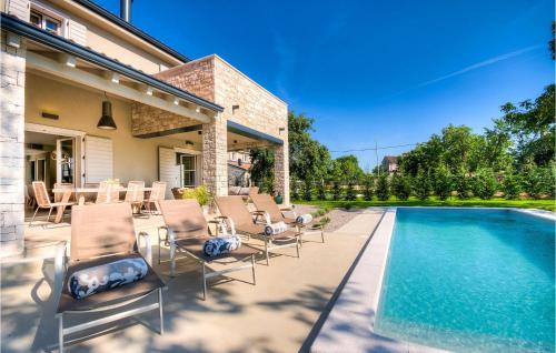 a patio with chairs and a swimming pool at Villa Mia in Šivati
