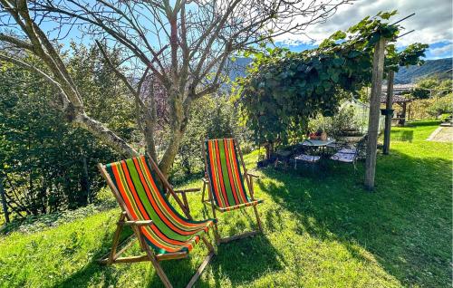 two chairs sitting in the grass in a yard at Lovely Apartment In Lamon With Wifi in Lamon