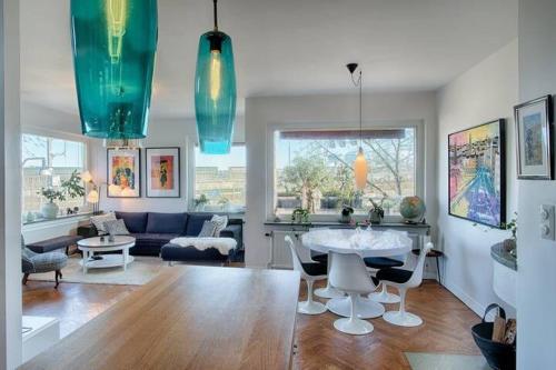 a living room with a table and a couch at Spacious 5 bedroom house in Stockholm in Stockholm