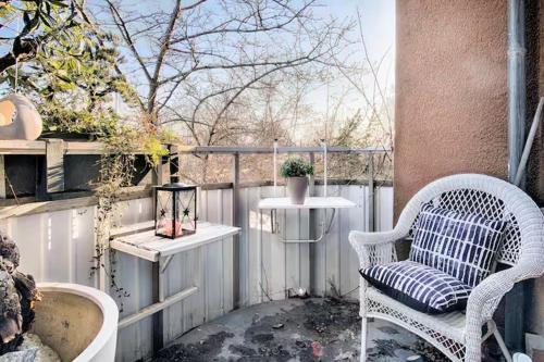a patio with a white chair and a table and a table at Spacious 5 bedroom house in Stockholm in Stockholm
