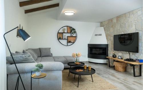 a living room with a couch and a tv at Villa Kalista Istriana in Pula