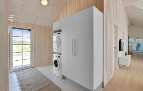 a white laundry room with a washer and dryer at Pet Friendly Home In Henne With Sauna in Henne Strand