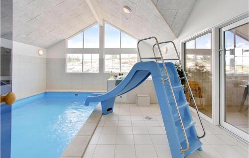 a house with a slide in a swimming pool at Pet Friendly Home In Henne With Sauna in Henne Strand