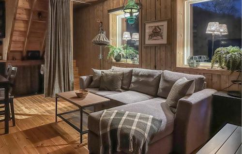 a living room with a couch and a table at 3 Bedroom Amazing Home In Tysse in Tysse
