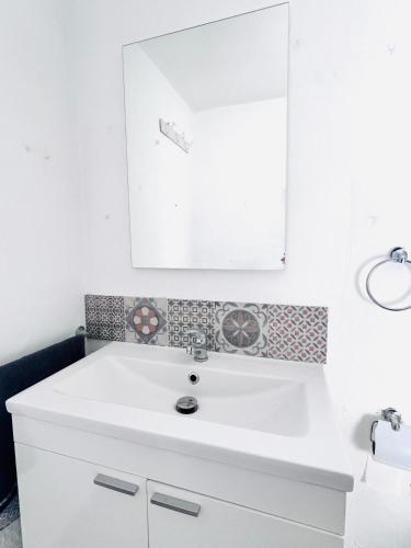 a bathroom with a white sink and a mirror at Villa Fátima Montepinar in Orihuela