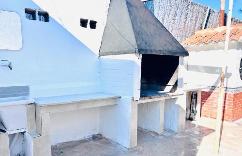 a white dog house with a blue roof at Villa Fátima Montepinar in Orihuela