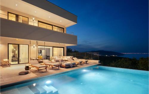 a villa with a swimming pool at night at Villa The View in Sveta Marina