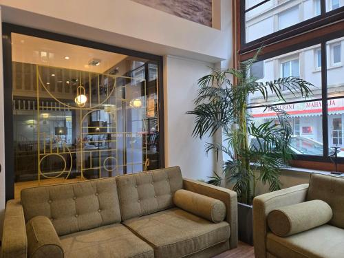 a living room with a couch in front of a store at Sure Hotel By Best Western Lorient Centre in Lorient
