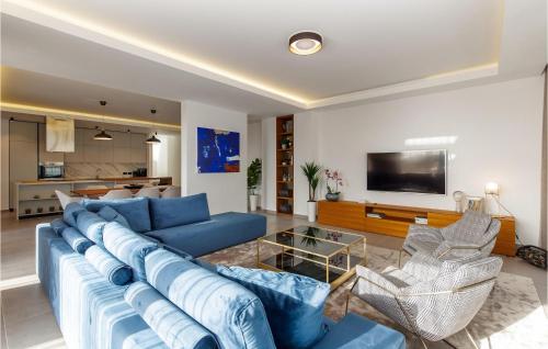 a living room with a blue couch and a tv at Villa Eleven in Rovinj