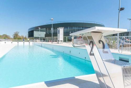 a swimming pool in front of a stadium at Camping 3 étoiles - Parc aquatique - ccaehgc in Déols