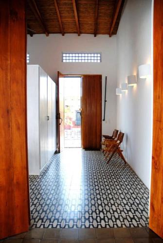 a hallway with a door to a room with a tile floor at Los Patios Hotel Granada in Granada