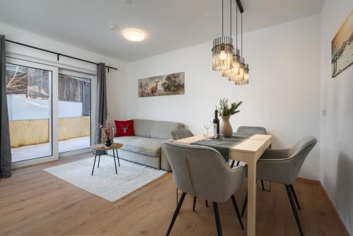 a living room with a table and a couch at Appartement Alpenzauber in Kirchberg in Tirol