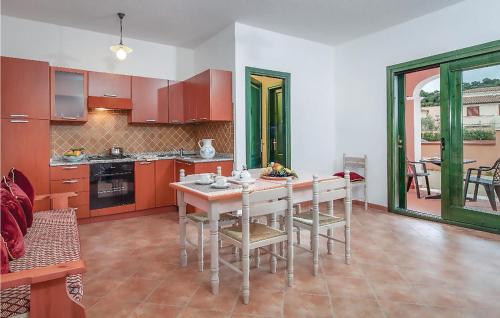a kitchen with a table and chairs in a room at Quadri in Orosei