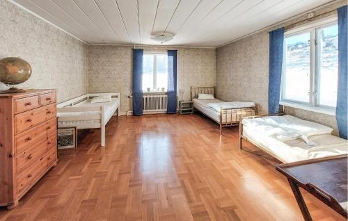 a room with two beds and a wooden floor at Nice Home In Torup With Wifi in Torup