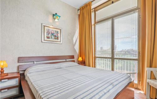 a bedroom with a bed and a large window at Awesome Home In Vitorchiano With Wifi in Vitorchiano
