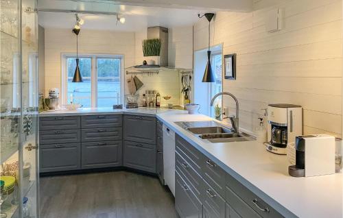 a kitchen with a sink and a counter top at Nice Home In Hjältevad With Sauna in Hjältevad