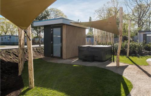 a small building with a television in a yard at Awesome Home In Voorthuizen With Wifi in Voorthuizen
