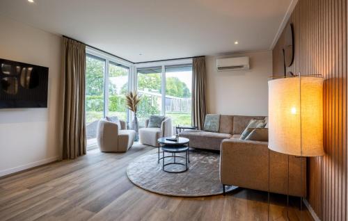a living room with a couch and a table at 2 Bedroom Gorgeous Home In Voorthuizen in Voorthuizen
