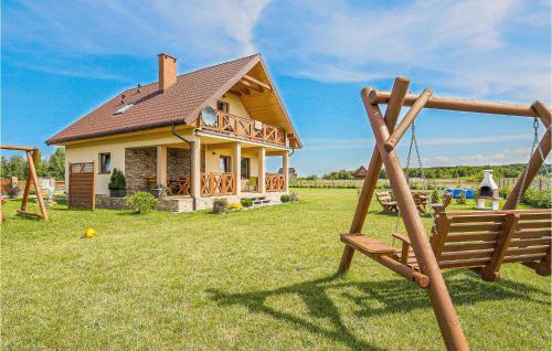 a house with a playground in front of it at 3 Bedroom Beautiful Home In Mscicie in Podamirowo