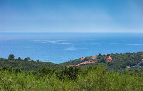 a village on a hill with the ocean in the background at Villa Ogradina in Pula