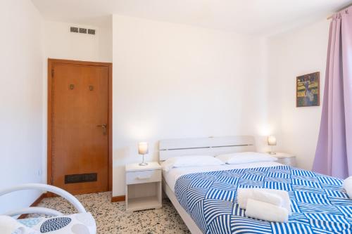 a bedroom with a blue and white bed and a chair at Bellavista - Residence in Barzio center near free ski shuttle in Barzio