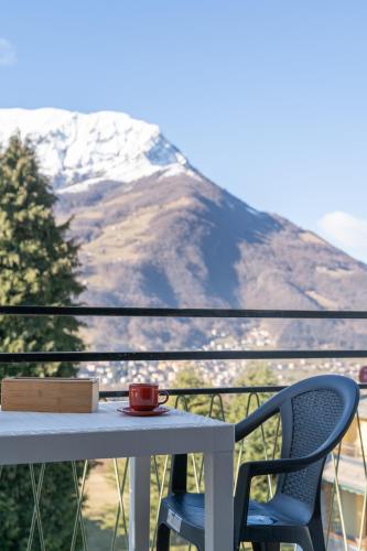 a table and chairs on a balcony with a mountain at Bellavista - Residence in Barzio center near free ski shuttle in Barzio