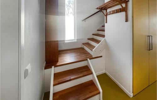 a staircase in a house with wooden steps at Nice Home In Mellerud With Sauna in Mellerud