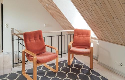 two orange chairs sitting on a staircase in a house at Nice Apartment In Simrishamn With Wifi in Simrishamn