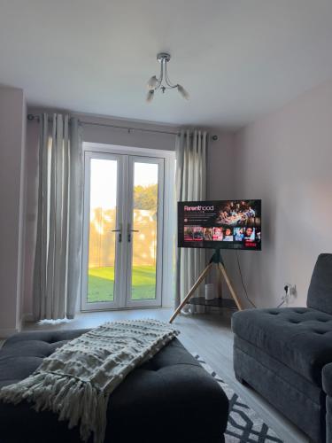 a living room with a couch and a window at JOY & House in Bristol