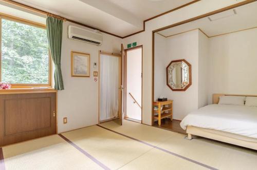 a bedroom with a bed and a window at Foresta Karuizawa 2 in Oiwake