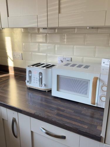 a kitchen with two microwaves on a counter at JOY & House in Bristol