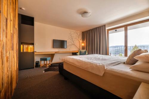 a hotel room with a bed and a desk at ENDEMIT Boutique Hotel & Spa in Horní Bečva