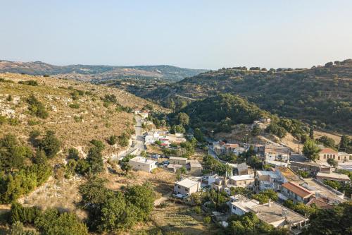 an aerial view of a small village in the hills at Villa Fotinou Heated Pool & Free Bikes awaits in Fotinós