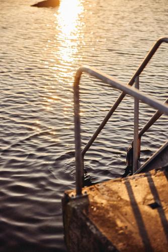 a boat in the water with a metal railing at Varbergs Kusthotell in Varberg