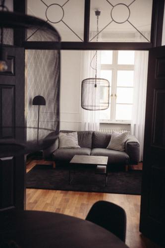 a living room with a couch and a window at Varbergs Kusthotell in Varberg