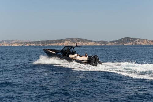 a boat in the middle of the water at Virtu Suites in Agios Prokopios