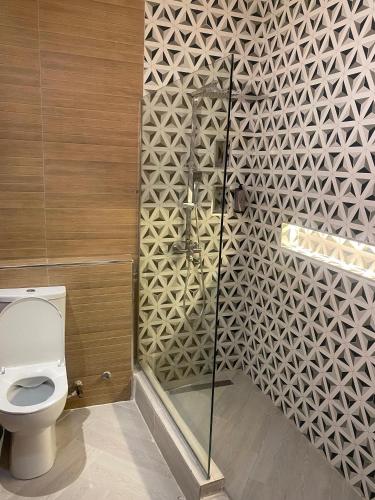 a bathroom with a toilet and a shower at Lala's Boutique Hotel in Lagos
