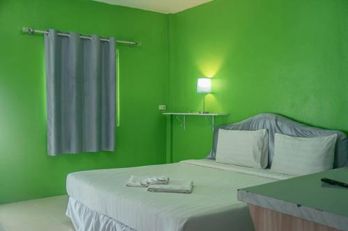 Una cama o camas en una habitación de Kongkhamkoon Hotel