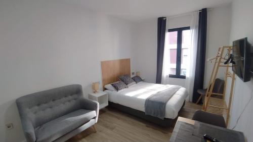 Ένα ή περισσότερα κρεβάτια σε δωμάτιο στο Apartamentos Recunchos
